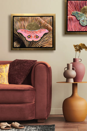 pink emperor gum moth mushroom painting in gold float frame hanging on wall over sofa