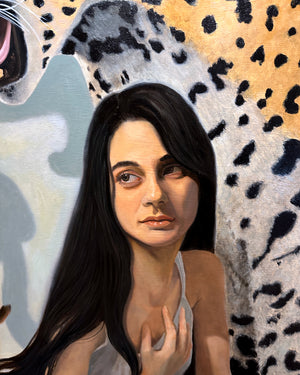 A close-up detail of a painting of a woman with long dark hair, shown against a large spotted jaguar in white, black, and tan.