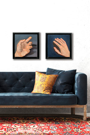 2 hand paintings hanging on wall