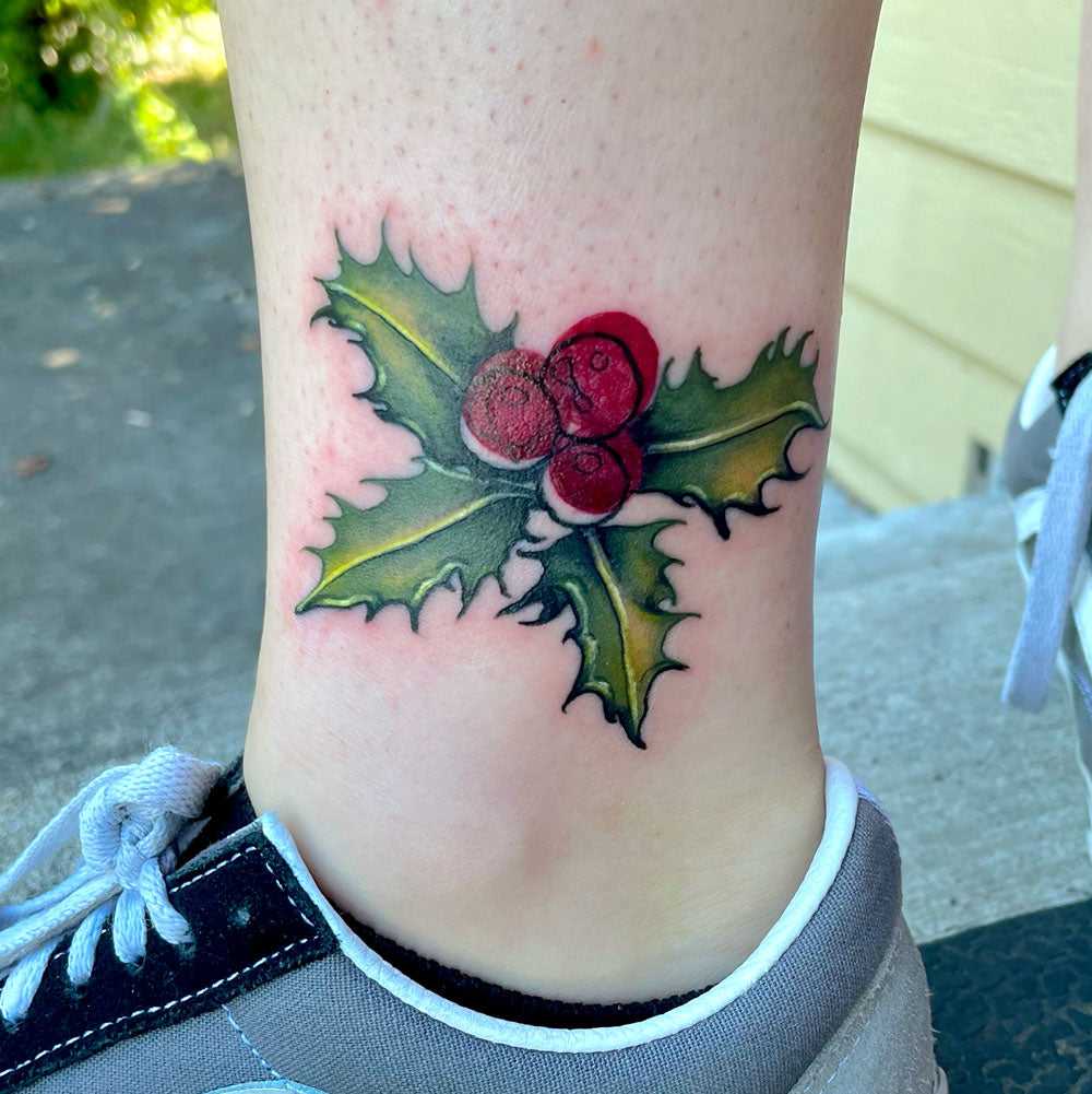 red and green holly tattoo