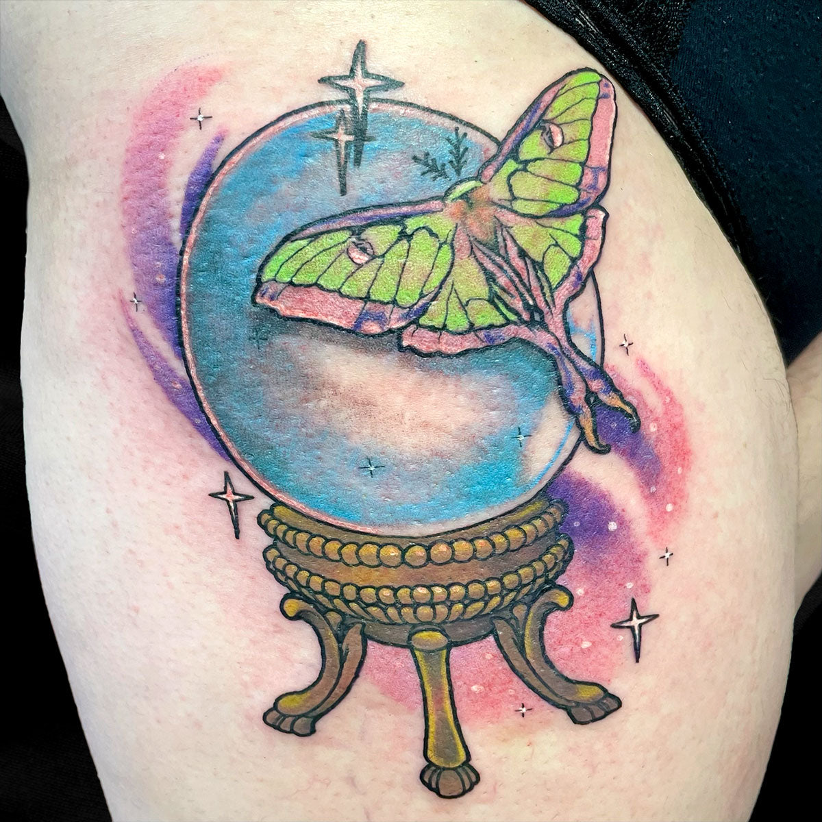 luna moth crystal ball color tattoo on thigh by Cass Brown