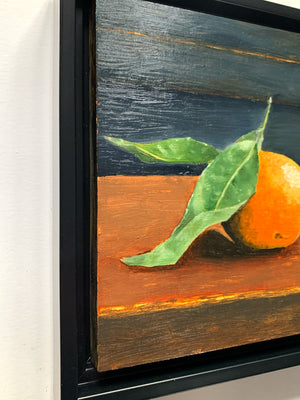 orange oil painting in black float frame