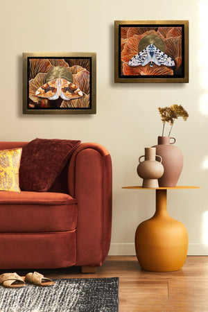 giant leopard moth mushroom painting in gold float frame hanging on wall over side table