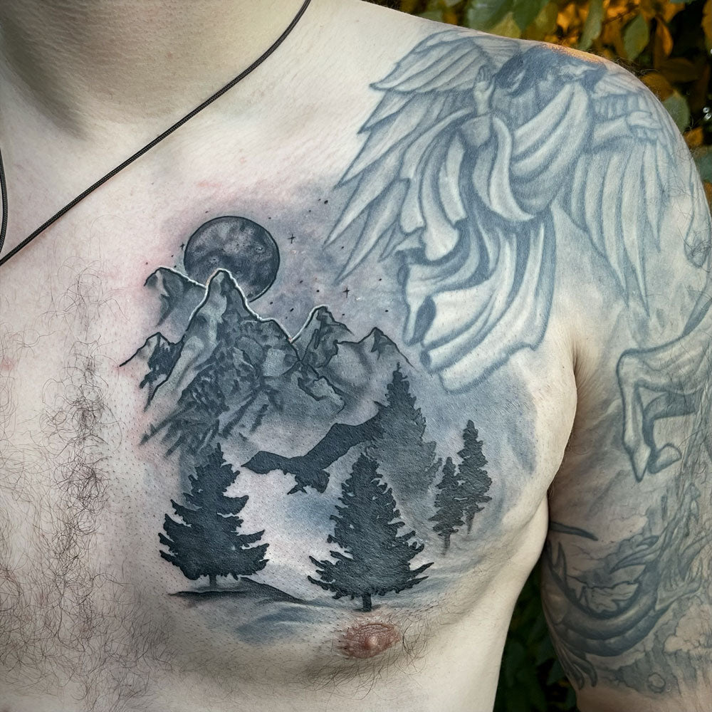 mountain and trees coverup tattoo by Cass Brown