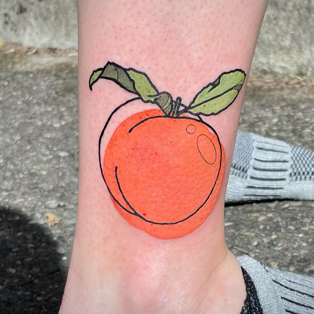 graphic orange peach tattoo on ankle