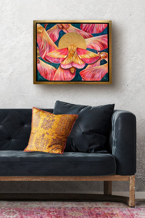 rosy maple moth painting on white wall over sofa