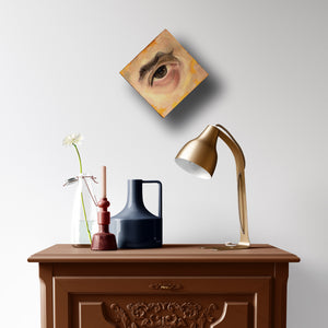 eye painting brown and yellow on wall