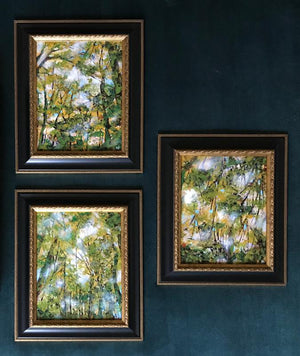 3 framed Fall forest nature paintings on teal gallery wall by Aimee Schreiber