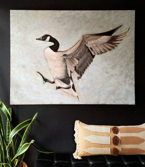 large goose painting on wall over bench