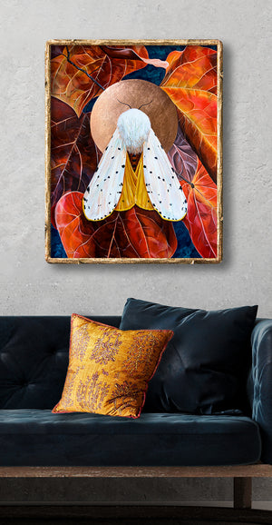 white moth art print with red leaves over sofa