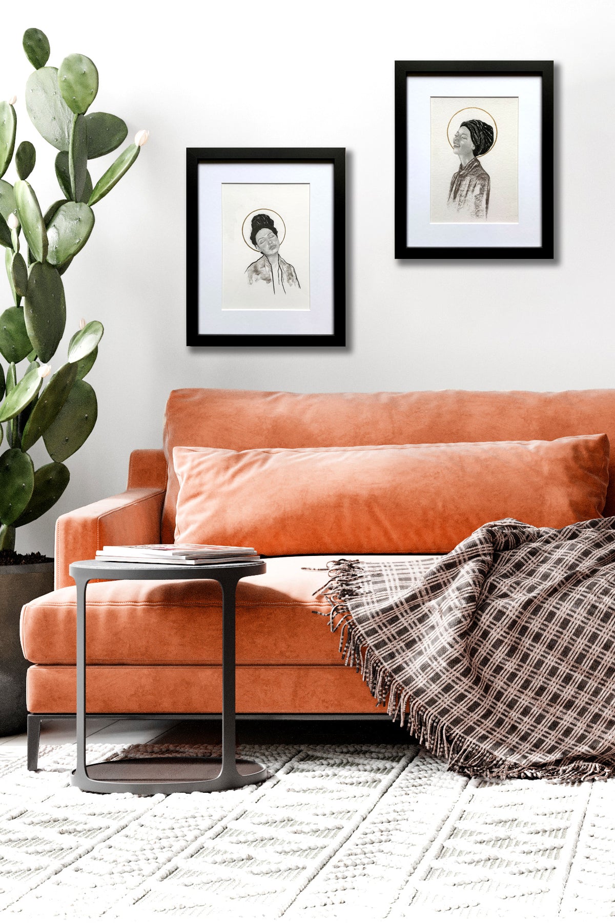 pair of joyful women portrait drawings hanging over sofa