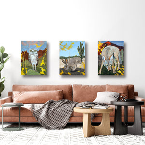 set of 3 desert animal paintings hanging over sofa