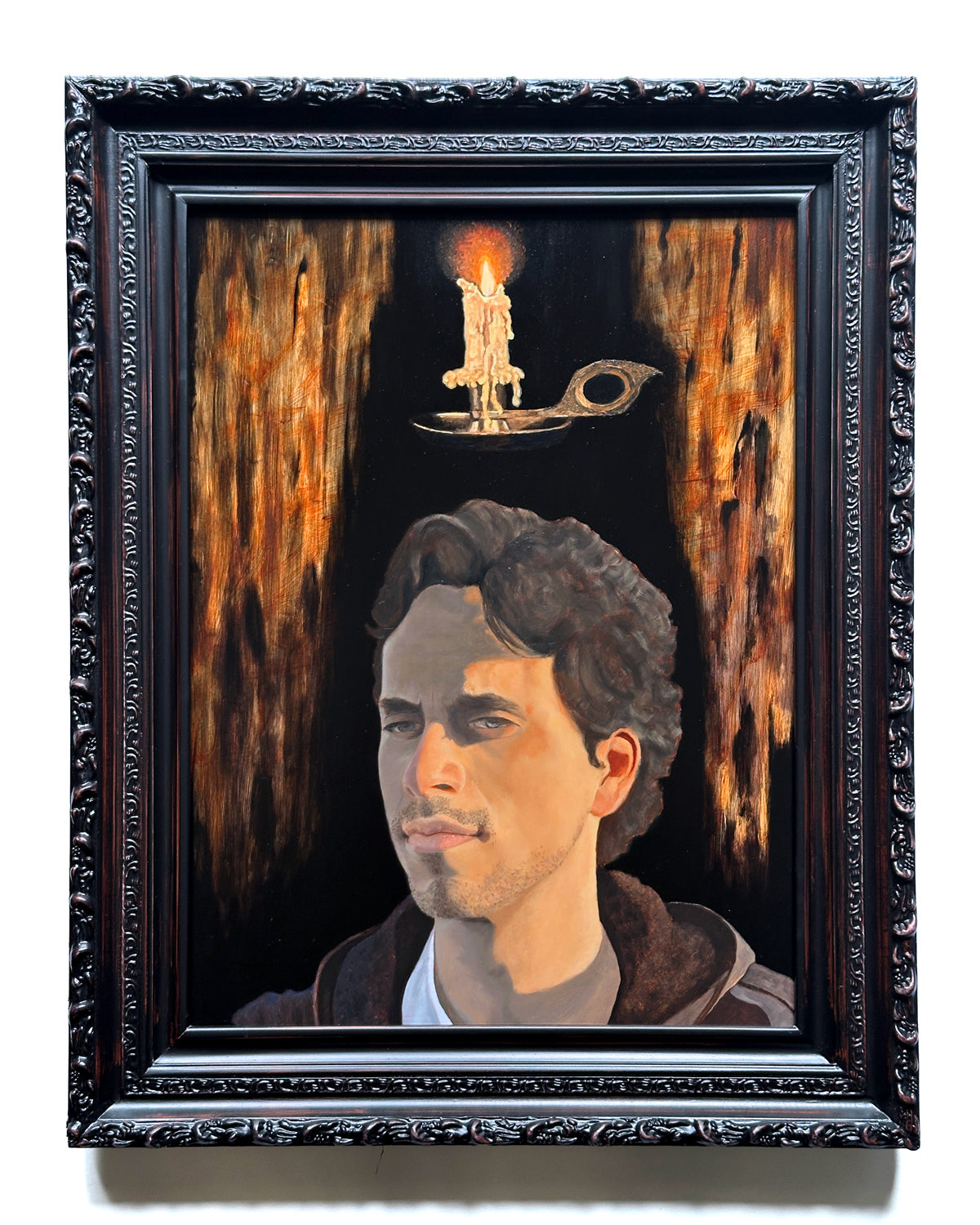 Oil painting by Danny Schreiber of man portrait with candle hovering over his head against a dark background framed in ornate dark frame