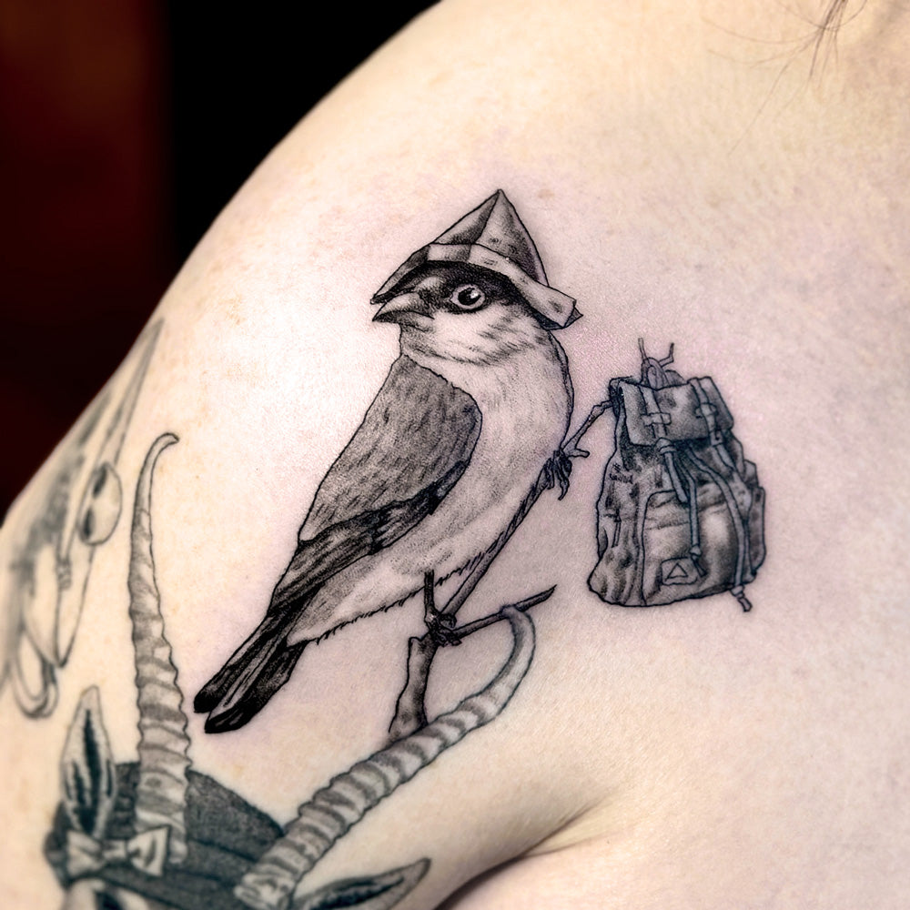 bird with a backpack tattoo by Danny Schreiber