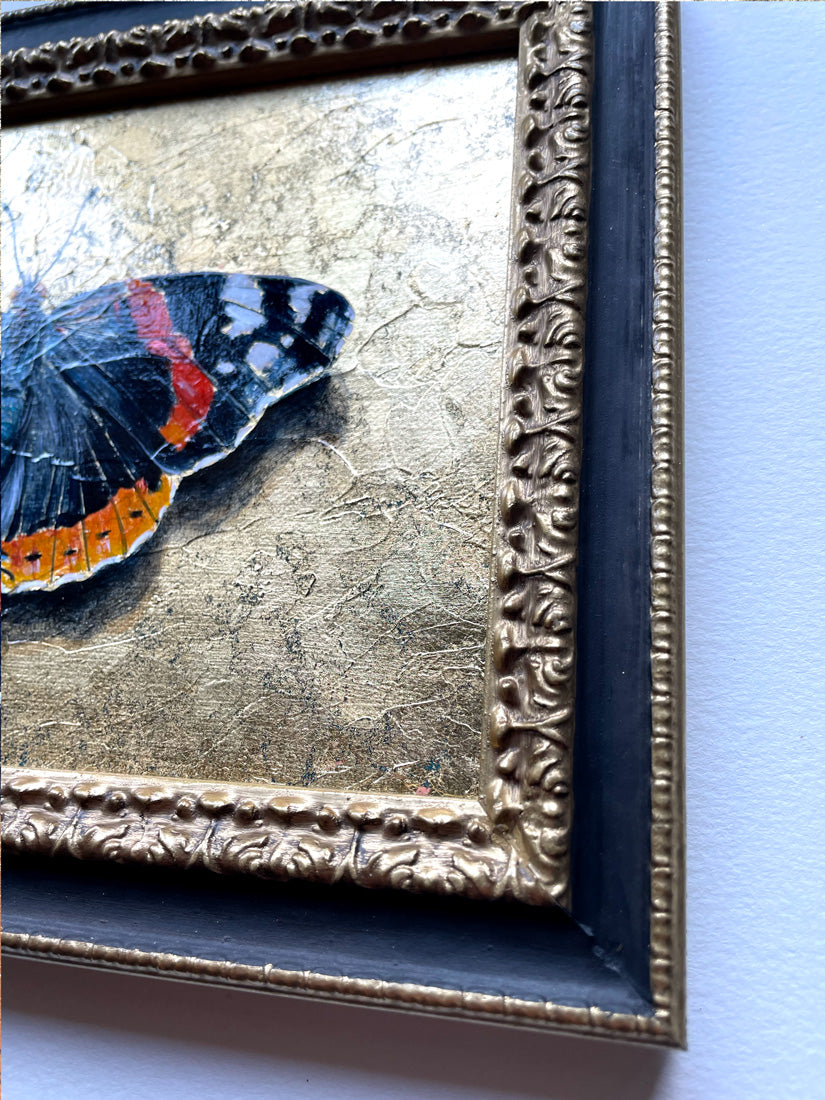 black butterfly painting ornate frame detail