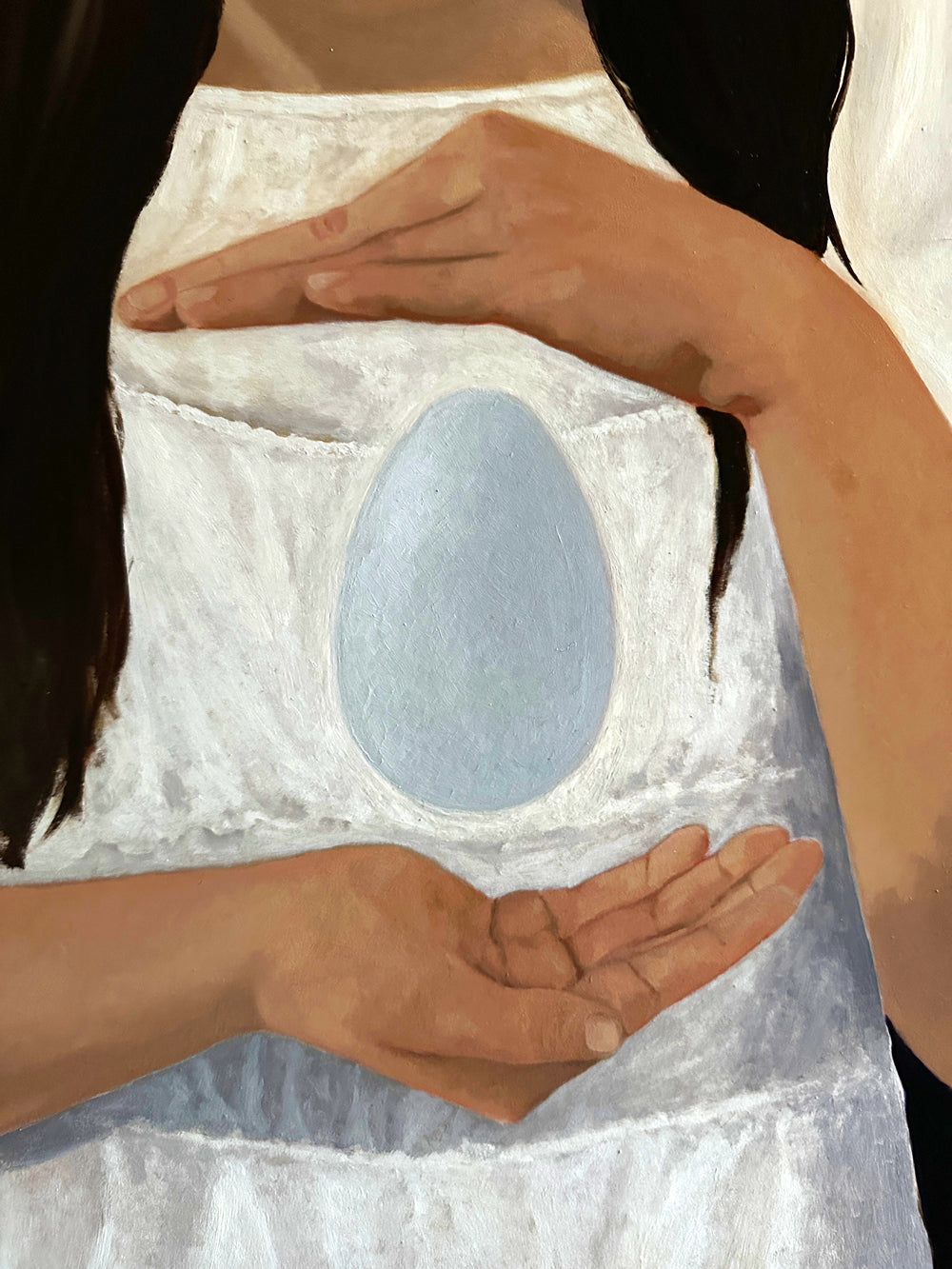 child holding egg painting detail