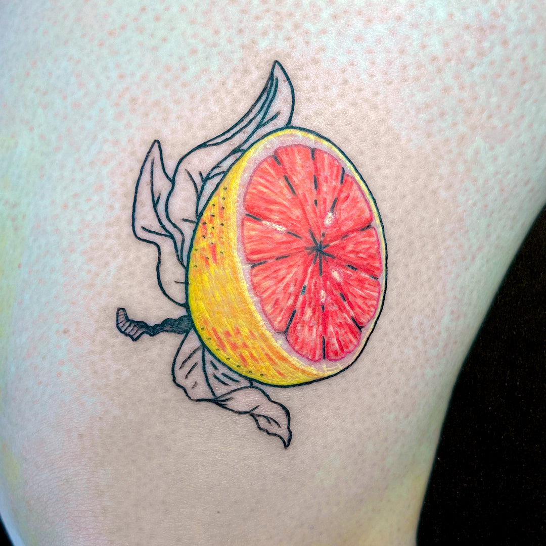 colorful grapefruit tattoo by Juniper Jack