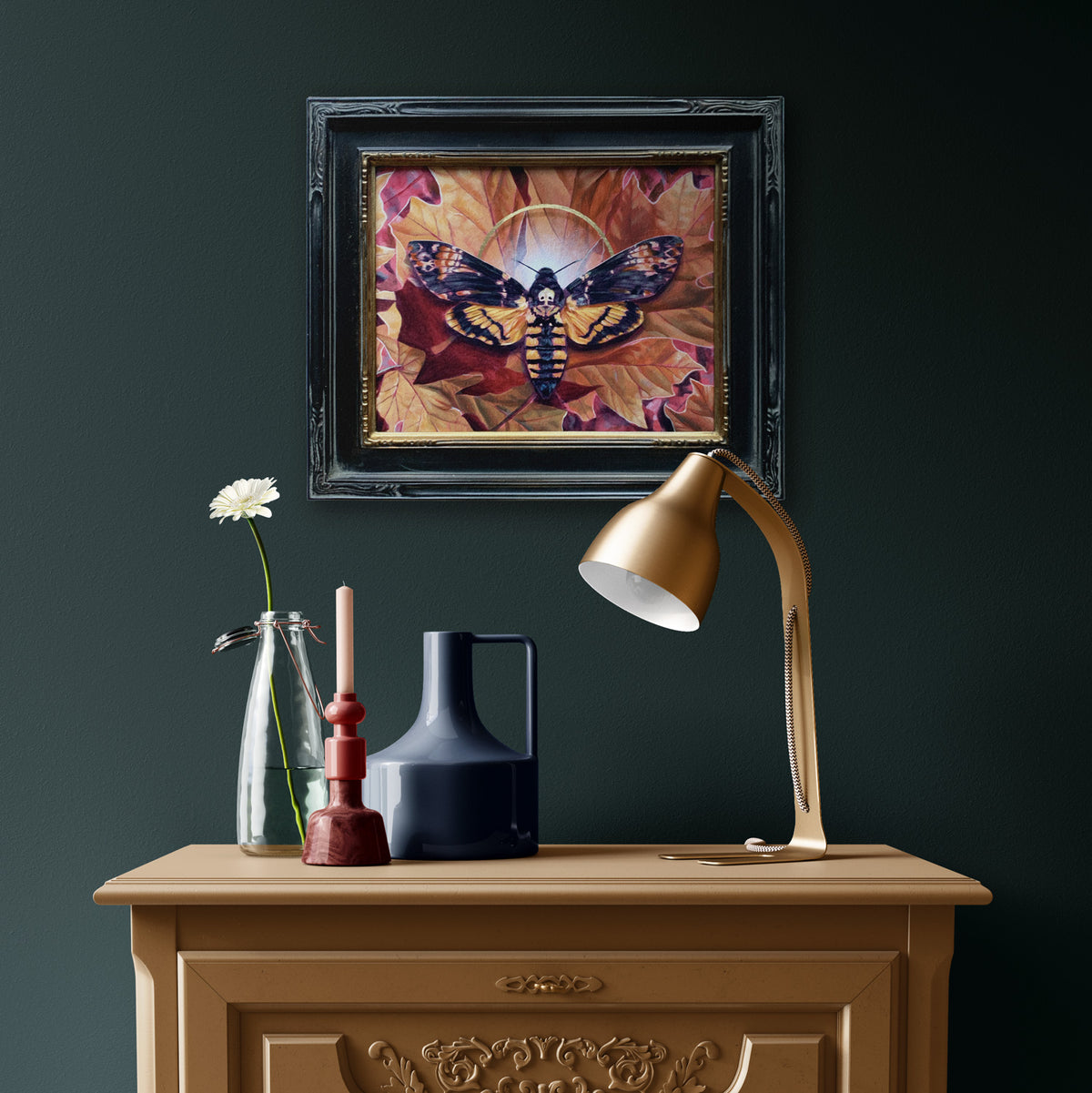 Transmutation death&#39;s head moth painting on dark green wall