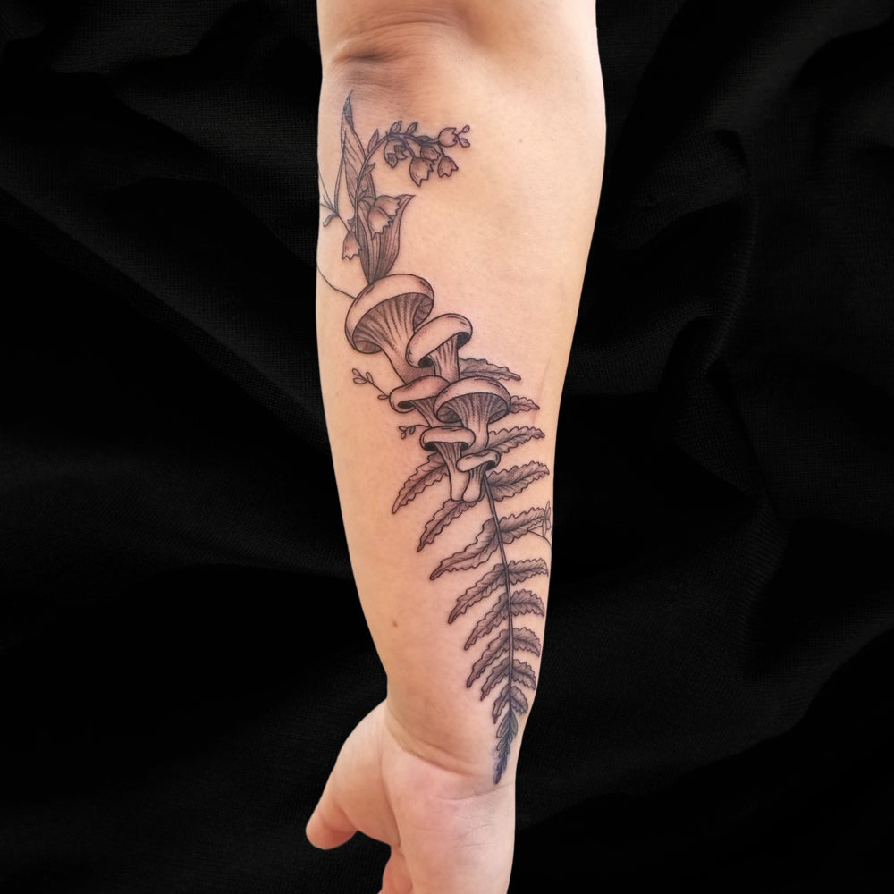 fern mushroom tattoo on forearm by Lydia Pitts