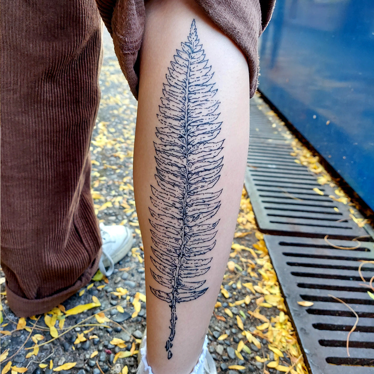 fern tattoo on calf by Vincent Li