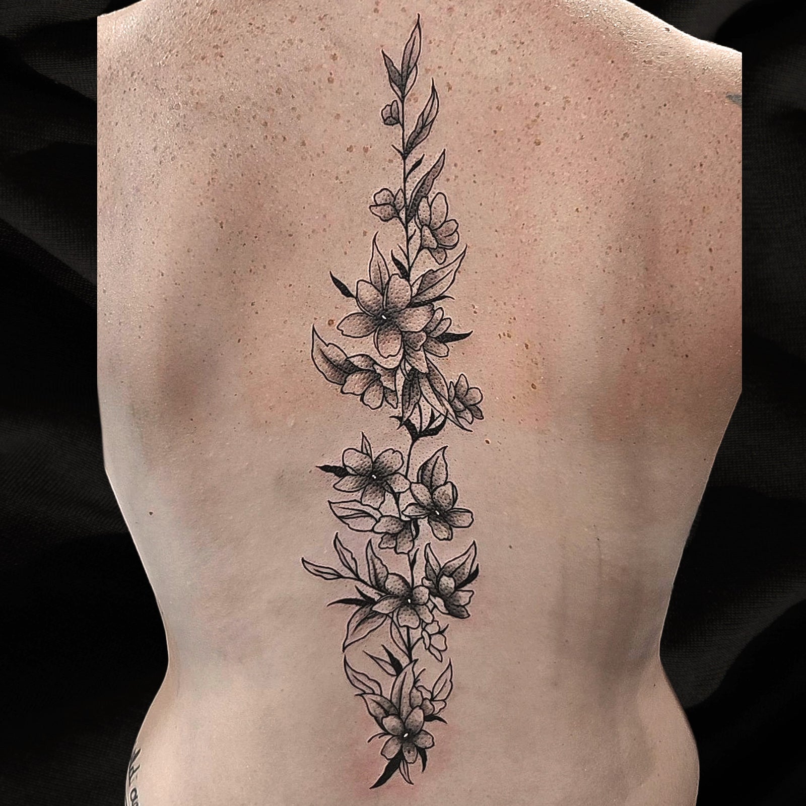 floral spine tattoo by Mary
