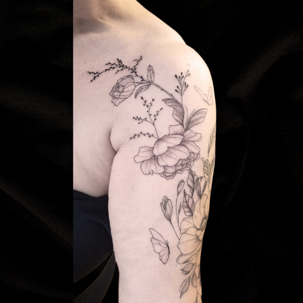 fine line flower shoulder tattoo by Lydia