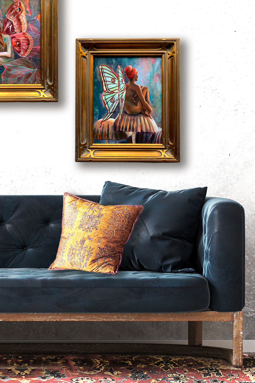 green wings fairy painting hanging on wall over sofa