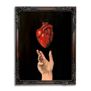 art print of an open hand with an anatomical heart hovering above it on a black background