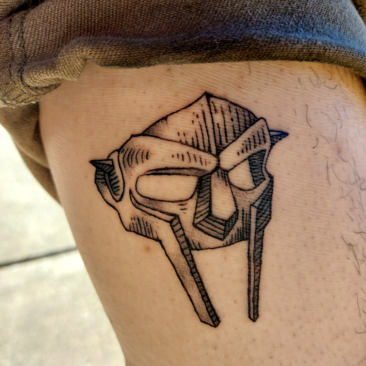 helmet tattoo on thigh by Vincent Li