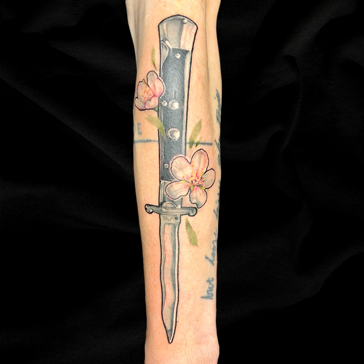 Hybrid realism knife tattoo by Cass Brown