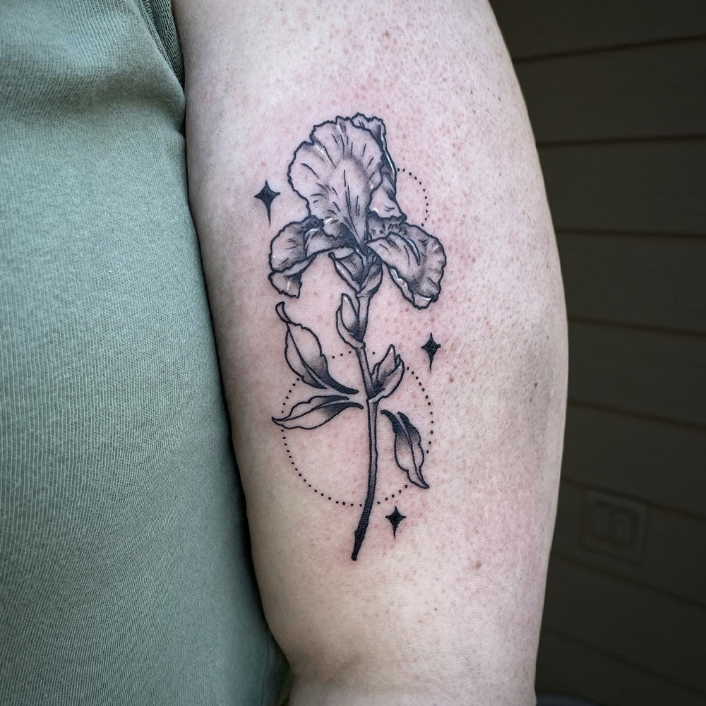 iris tattoo on bicep by Cass Brown