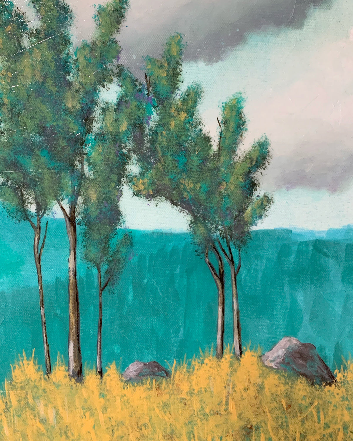 teal and yellow landscape painting with trees, clouds, and mountains detail