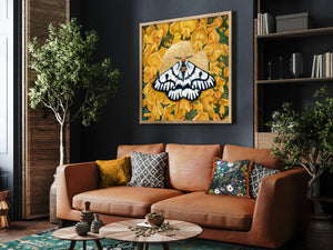 large moth and yellow flower wall art hanging over sofa