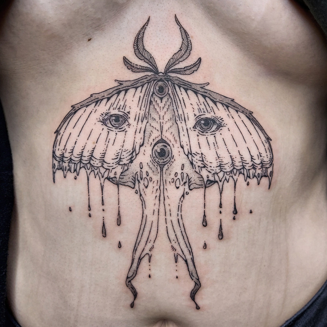 Illustrative moth tattoo on solar plexus by Vincent Li