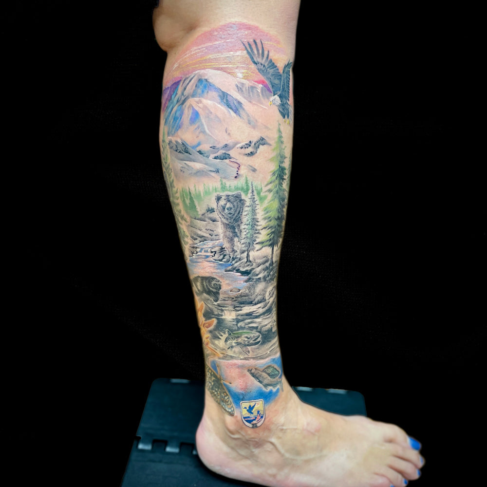 bear wilderness landscape leg sleeve tattoo by Cass Brown