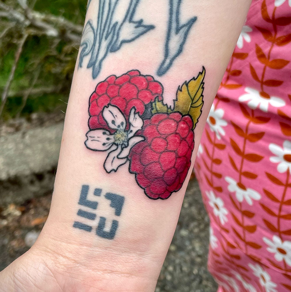 raspberry tattoo on forearm