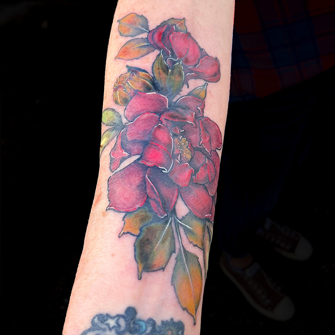 red peony tattoo on forearm by Cass Brown