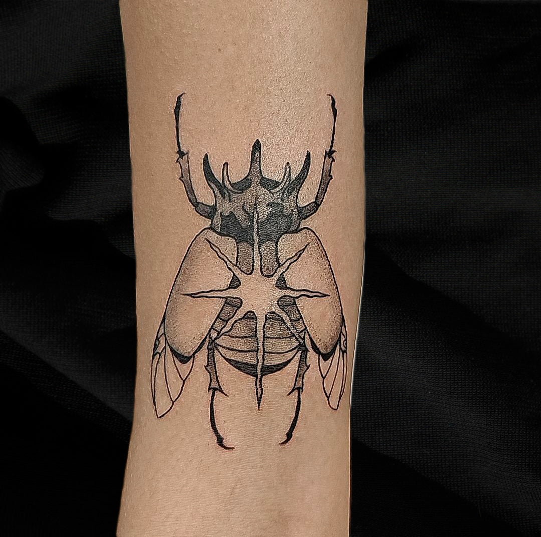 Rhinocerous beetle tattoo by Mary Kuzmin