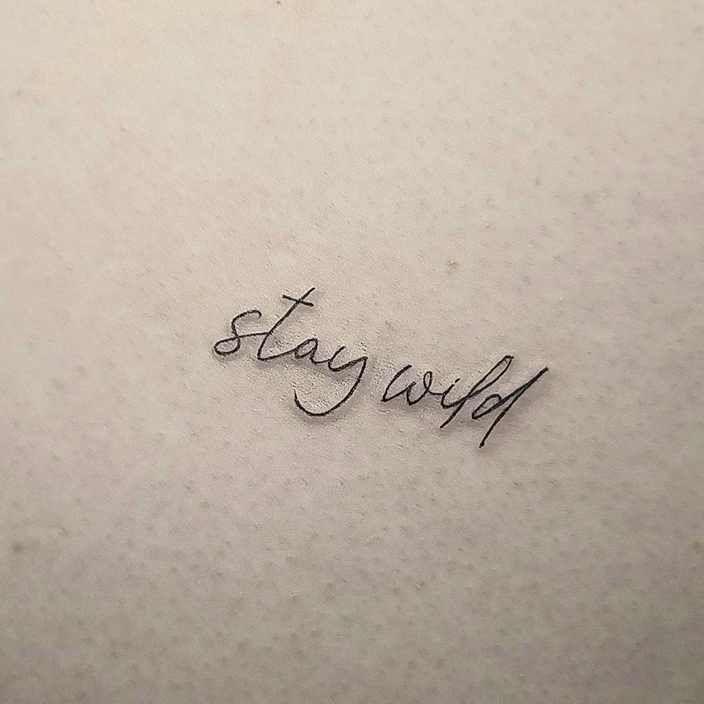 stay wild text tattoo by Mary Kuzmin