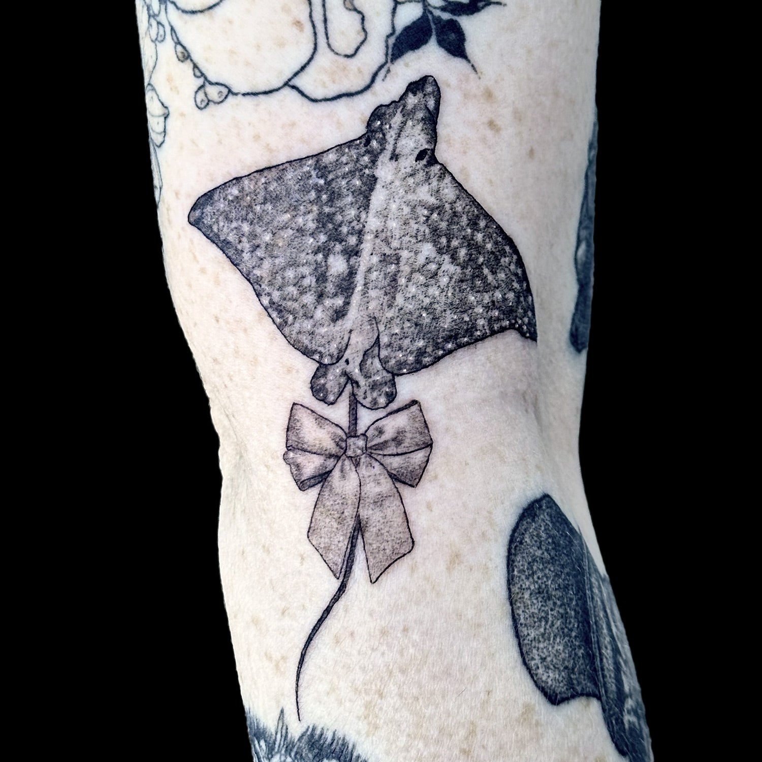 sting ray with bow tattoo by Danny Schreiber