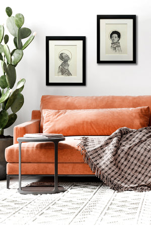 two women portrait drawings over sofa