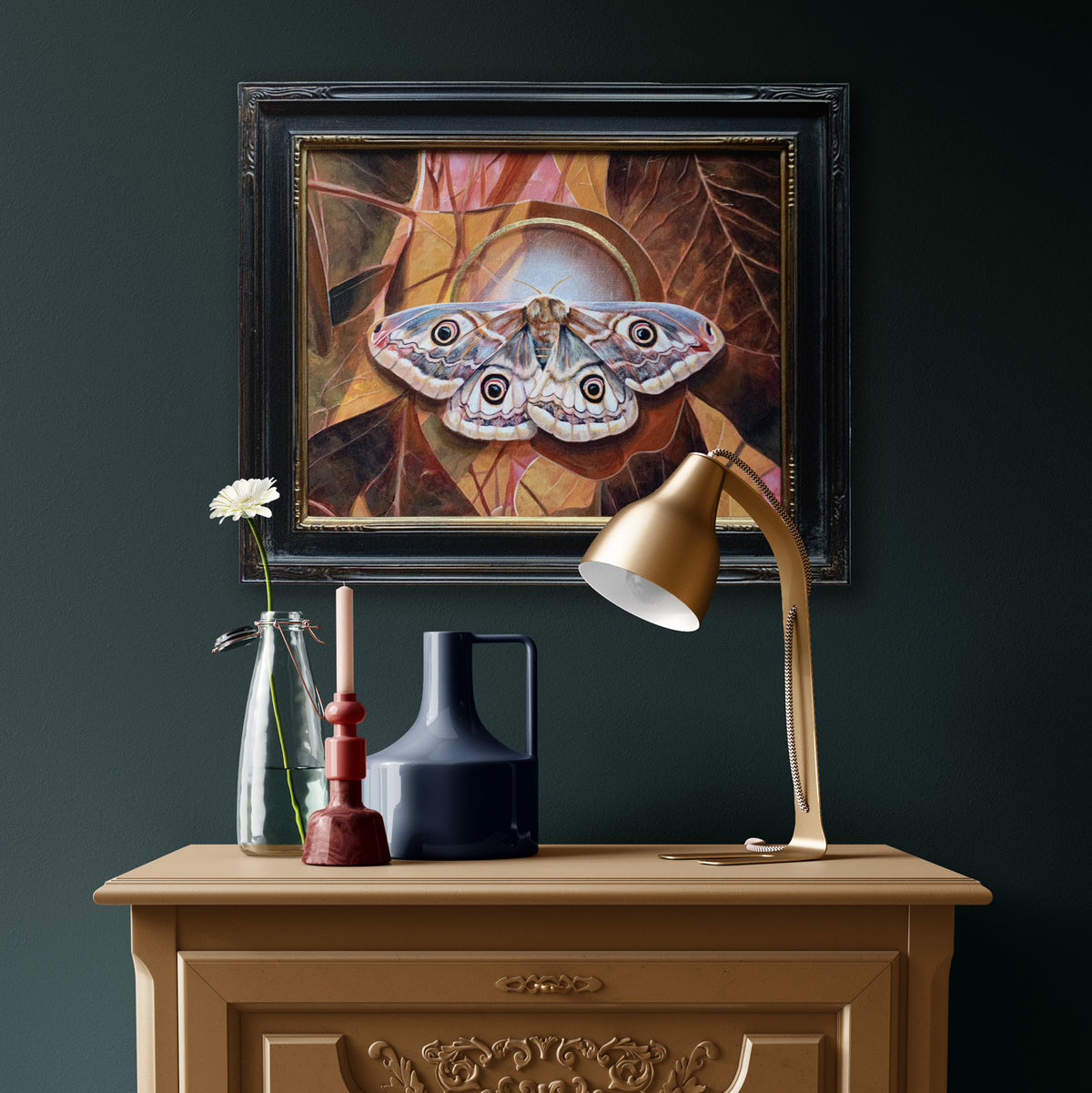 &#39;Glimmer&#39; female emperor moth painting hanging on dark green wall