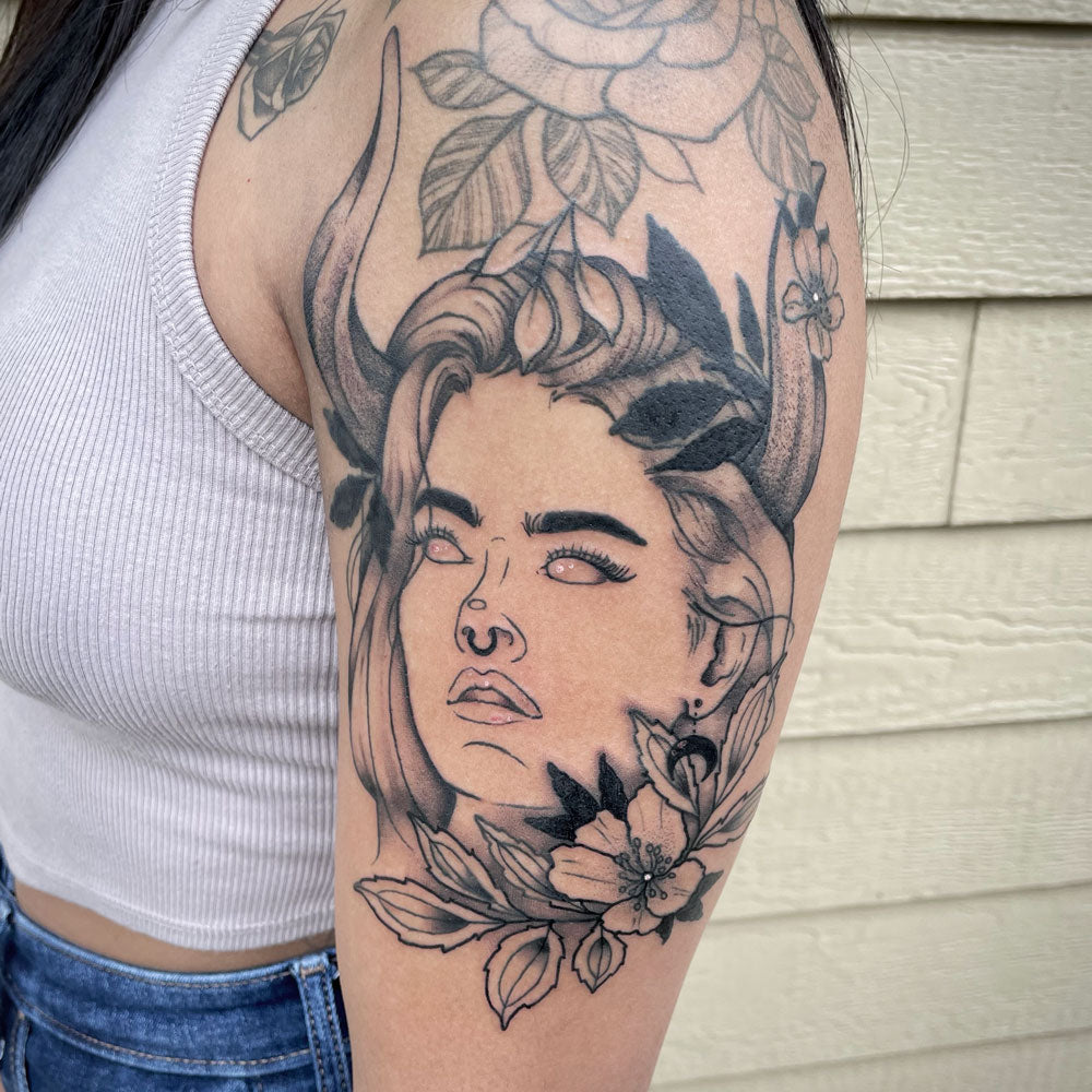 woman portrait tattoo on bicep