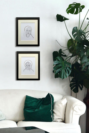 portrait drawings pair over sofa