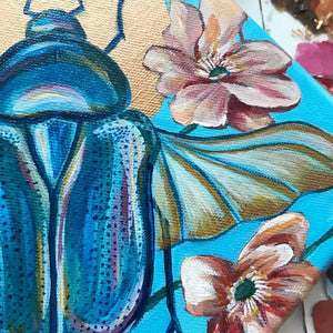 scarab beetle painting with flowers and copper halo close up