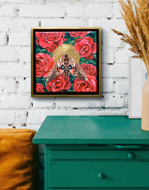 blinded sphinx moth and red roses painting framed on brick wall