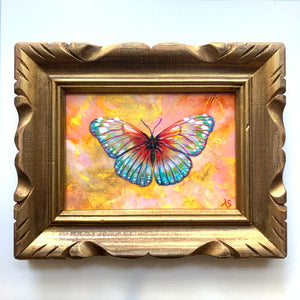Colorful summer butterfly original painting in an antique wood frame on white wall