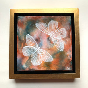 Ethereal moths colorful original painting by Aimee Schreiber in a gold floater frame on white wall