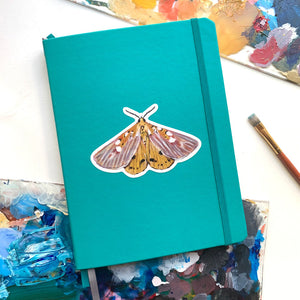 golden moth sticker on journal