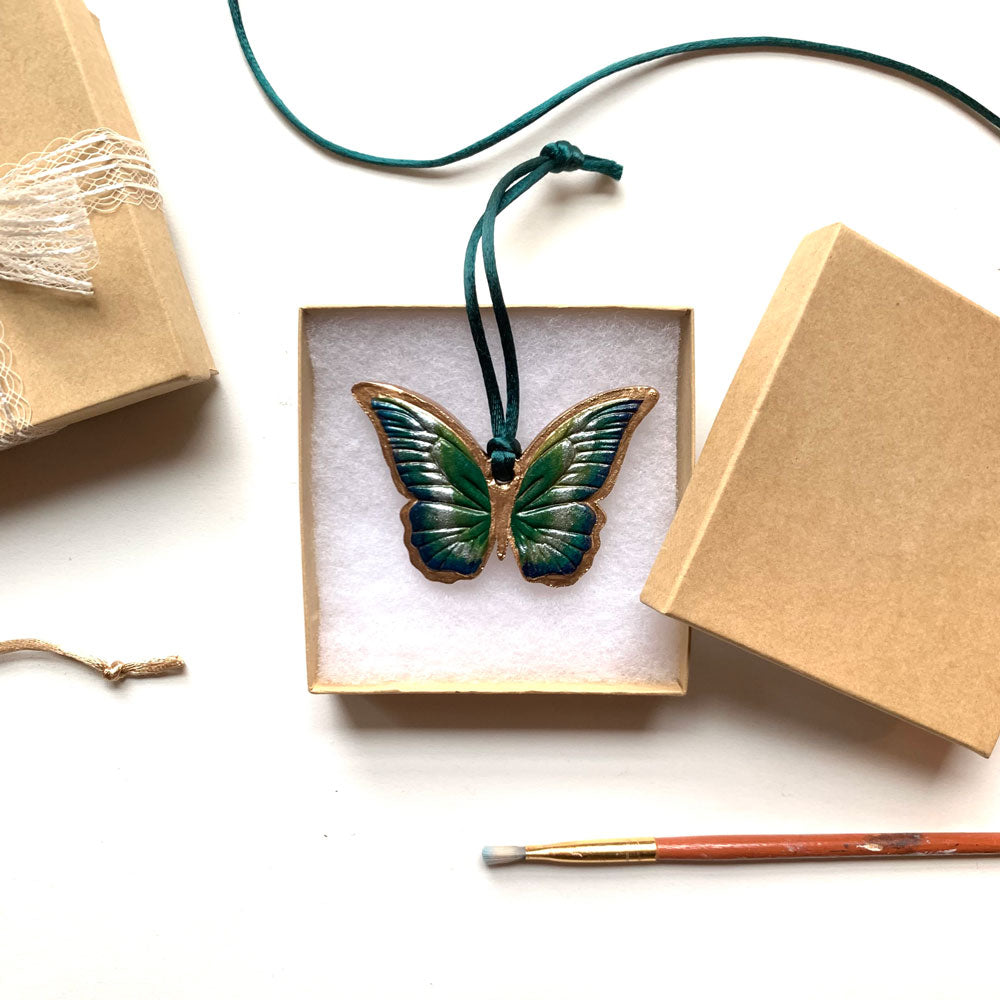 green blue gold butterfly ornament in gift box